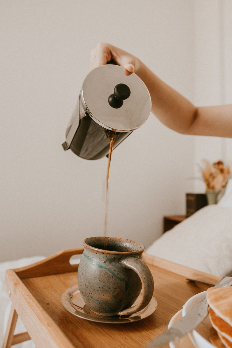 Pouring Coffee on Ceramic Cup