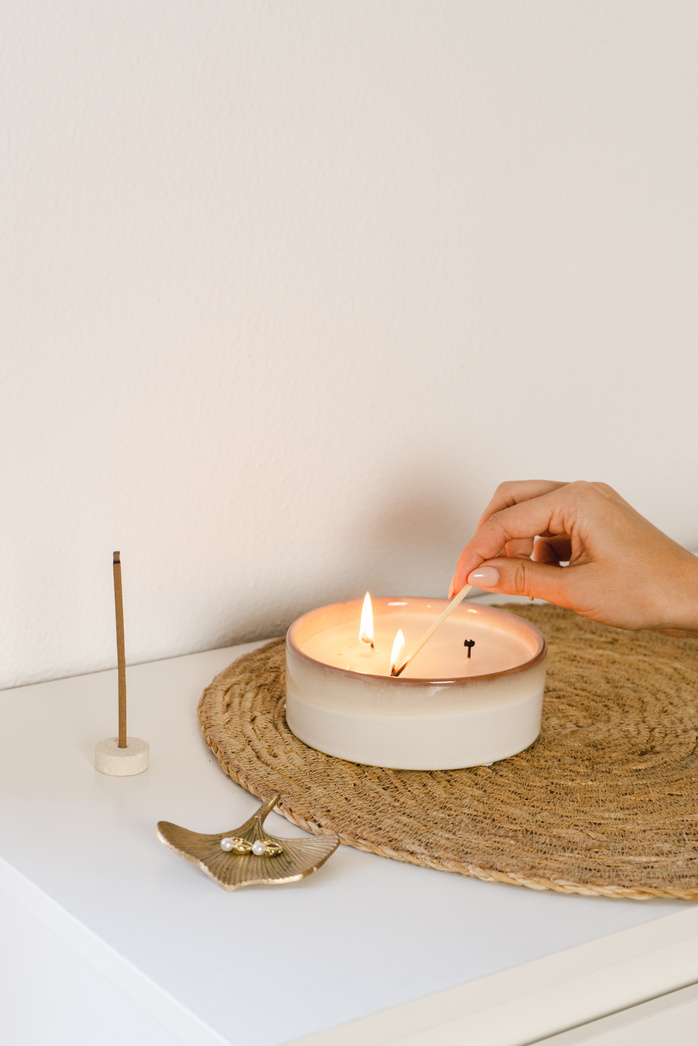 Woman Lighting a Candle